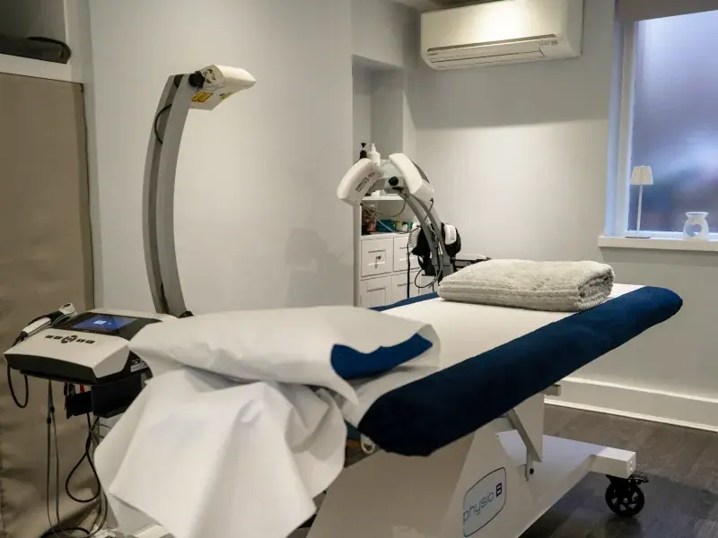 Treatment bed with a folded towel and physiotherapy equipment