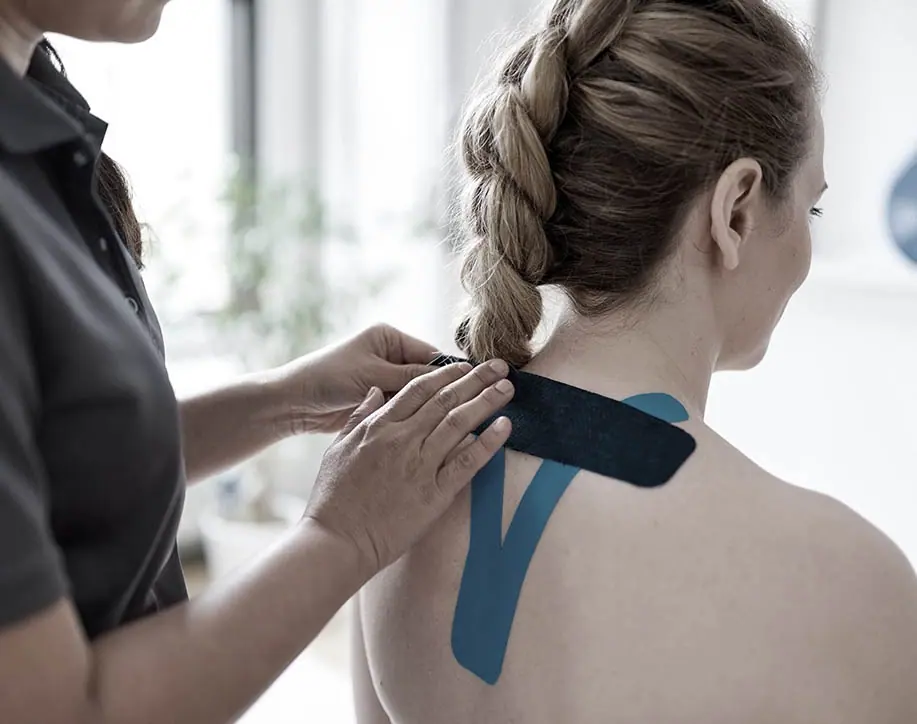 Kinesiology tape being applied to the neck and shoulder