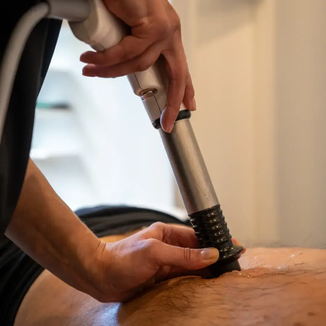 Close-up of a shockwave applicator during treatment